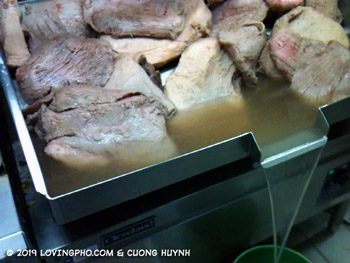 Draining parboiled beef for pho broth